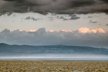 Owens Dry lake with storm and alkali dust cloud, CA.