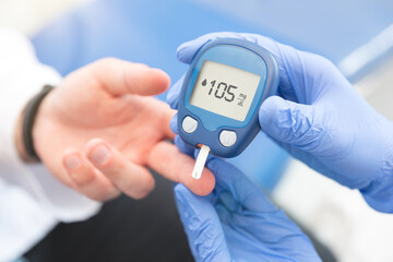 Doctor making blood sugar level test in clinic