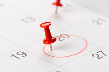 red buttons on the calendar. Concept idea for planning. An important date, business trip, or meeting reminder.