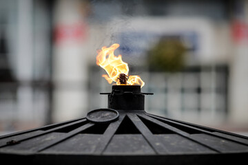 Details with an oil fueled eternal flame at a war memorial monument in Bucharest, Romania.