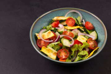 Traditional Arabic fattoush salad on a plate on the table.