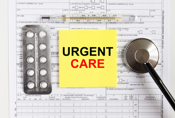 Text Urgent Care on yellow sticker with a stethoscope and pills are on medical documents