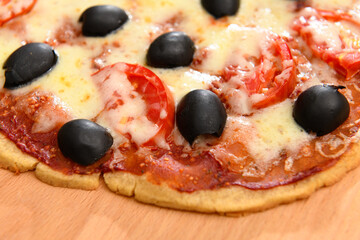 homemade pizza, vegetarian food, baked vegetables and cheese, tomatoes and olives, delicious food on a wooden background