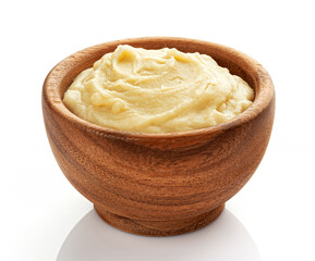 Mashed potato puree in wooden bowl isolated on white background