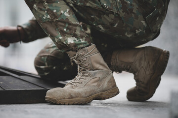 Shallow depth of field (selective focus) image with the boots and uniform of a Romanian soldier.
