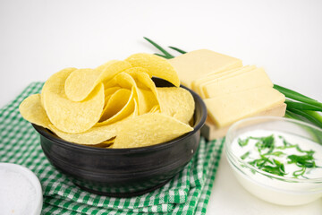 Chips with different flavors concept. Chips with cheese, sour cream sauce and green onion