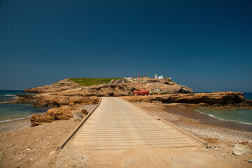 Path to the peninsula with villa and church near koumpara beach