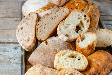 bread many different kinds of bakeciabata, rye, wheat and more  assortment of pastries black and white, healthy meal snack top view copy space for text food background rustic