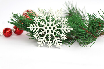 The 
white
snowflake for decorating  Christmas ball for  tree  on a white background. Spruce branch and  balloon in sparkles