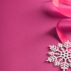 Christmas tree decoration in the form of snowflakes with sparkles on  background,  ribbon 