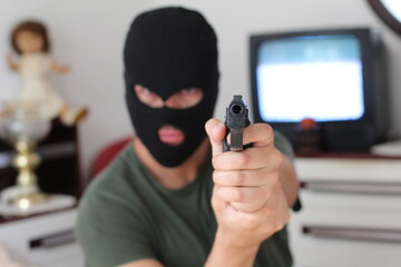 Spooky intruder holding a gun
