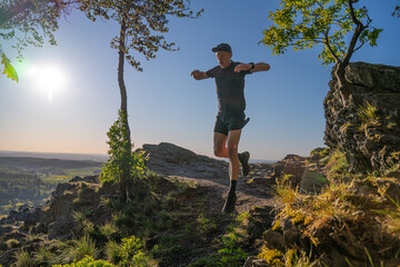 Trail Runner runs down the rocky mountains