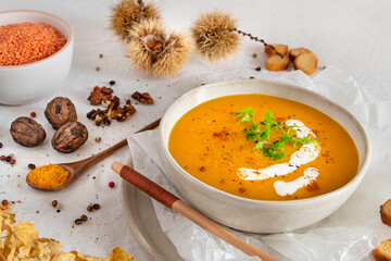 Orange soup in a bowl, pumpkin, carrot or coral lentils