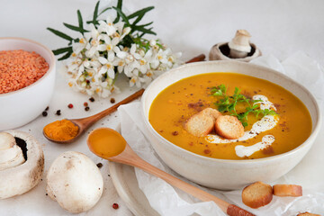 Orange soup in a bowl, pumpkin, carrot or coral lentils