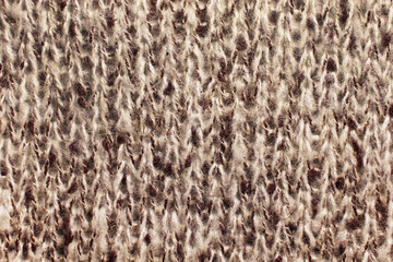 Crocheted beige wool texture. Cozy warm background