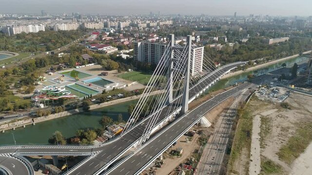 Aerial footage of a suspended bridge in Bucharest on a sunny day