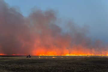 flames and smoke from burning farm field