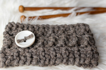 hand made winter headband and knitting needles 