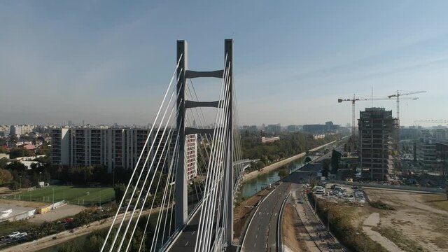 Aerial footage of a suspended bridge in Bucharest on a sunny day