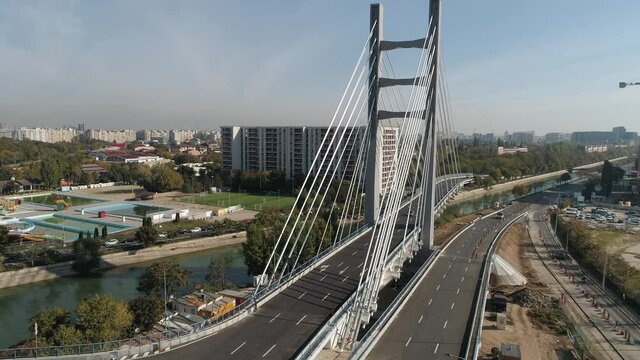 Aerial footage of a suspended bridge in Bucharest on a sunny day