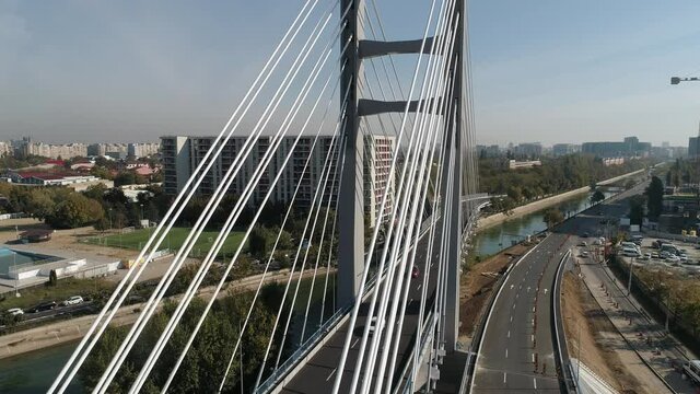 Aerial footage of a suspended bridge in Bucharest on a sunny day