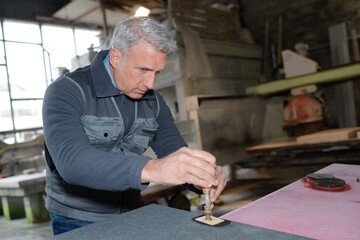 senior craftsman in a workshop