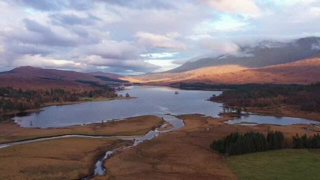 aerial drone shot over Loch Tulla in glen orchy near bridge of orchy in the argyll region of the highlands of scotland during autumn