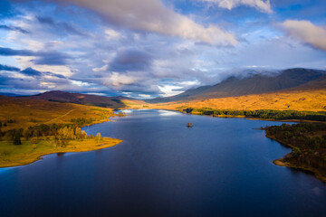 aerial drone shot over Loch Tulla in glen orchy near bridge of orchy in the argyll region of the highlands of scotland during autumn