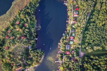 Naklejka na ściany i meble Drone view of summer cottages over Narie lake of Ilawa Lake District in Kretowiny, small village in Warmia Mazury region of Poland