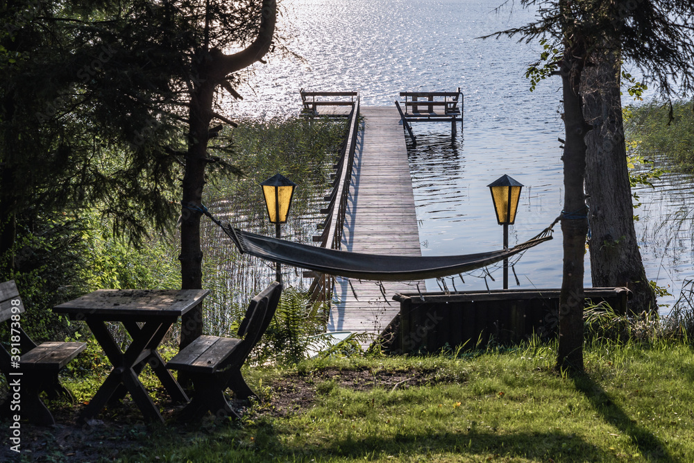 Poster Small pier on Narie lake of Ilawa Lake District in Kretowiny, small village in Warmia Mazury region of Poland