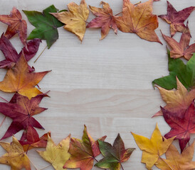 Naklejka na ściany i meble wooden texture with autumn leaves