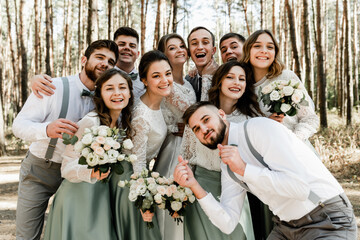 group of young people hugging tightly and laughing cheerfully,a group of friends celebrating a...