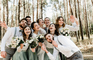 group of young people hugging tightly and laughing cheerfully,a group of friends celebrating a...