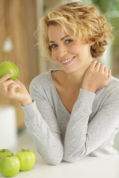 woman hlding a ripe green apple