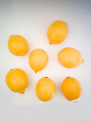 Top view of colorful fresh lemons on white background