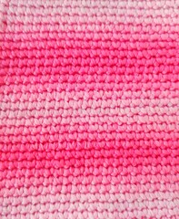 Knitted fabric pink and white horizontal stripes. Pink gradient.