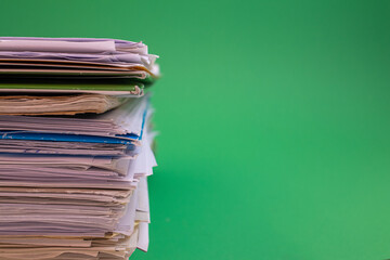 stack of paper against a green background