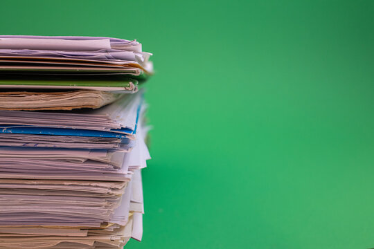 stack of paper against a green background
