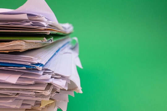 stack of paper against a green background
