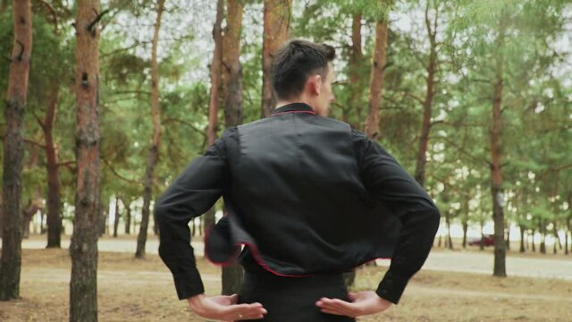 Close up of young man in black costume are dancing Traditional Spanish dance in summer forest