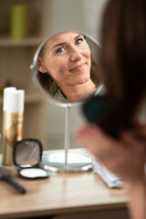 a woman is applying makeup
