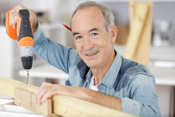 senior man working on tools in home
