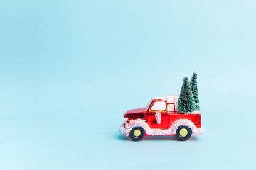 red car with a christmas tree and gifts on a blue background. 