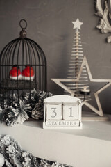 Christmas cozy decoration in white colors with wooden calendar, toys and candles