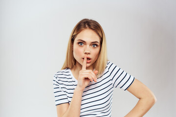 emotional woman in striped t-shirt gesture with hands lifestyle light background