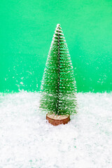 Christmas tree and snow on green background.New Year concept