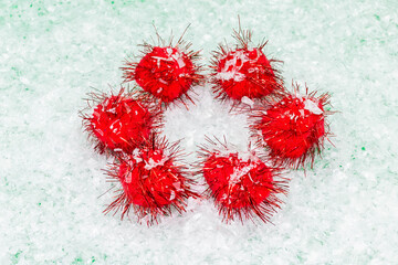 Minimal composition of fluffy red balls on snow white background.New Year and Christmas concept