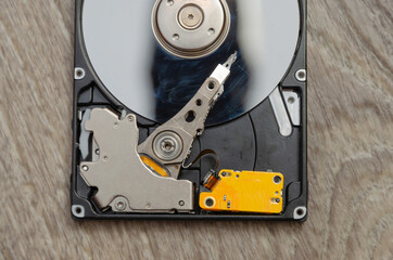 Disassembled hard drive from the computer, hdd with mirror effect. Part of computer pc, laptop