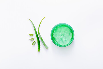 Organic aloe gel with aloe leaves on white background. Top view