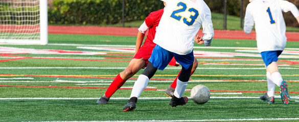 Soccer player dribbling the ball around his opponent during a match
